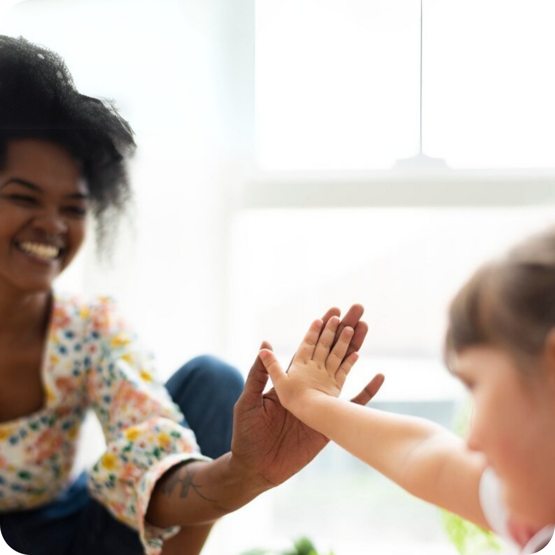 a woman and a child touching hands each other